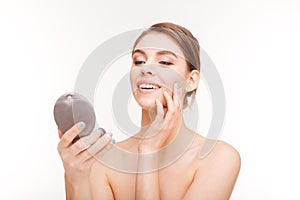 Smiling woman holding mirror