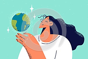 Smiling woman holding planet earth in hands
