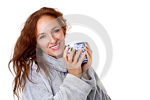 Smiling woman holding porcelain mug