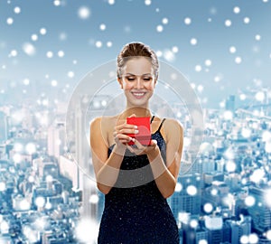 Smiling woman holding red gift box