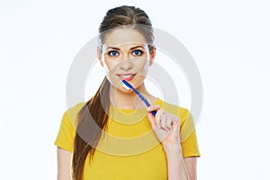 Smiling woman holding toothy brush. Isolated studio portrait.