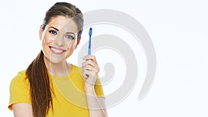 Smiling woman holding toothy brush. Isolated studio portrait.