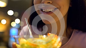 Smiling woman holding vegetable salad closeup sitting in cafe, healthy lifestyle