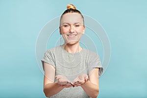 Smiling woman holding virtual object empty palms