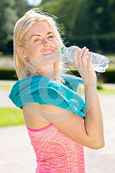 Smiling woman holding water bottle