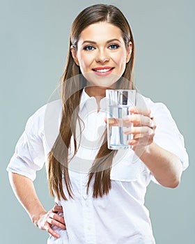 Smiling woman holding water glass. Isolated portrait of young m