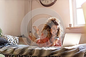 Smiling woman at home shopping online