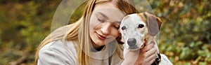 Smiling woman hugging gently her dog