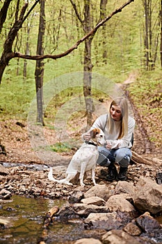 Smiling woman hugging gently her dog