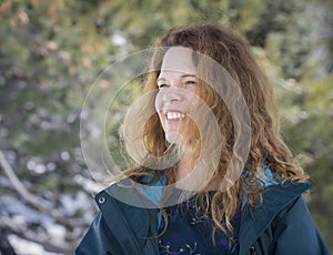 Smiling woman in jacket outside in winter