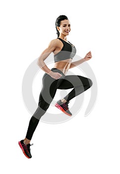 Smiling woman jumping on white background.