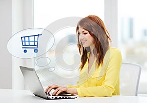 Smiling woman with laptop computer shopping online