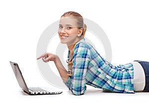 Smiling woman with laptop and pointing finger