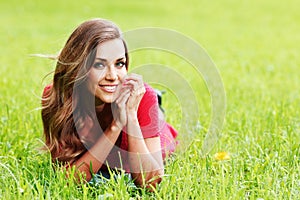 Smiling woman laying on grass