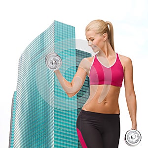 Smiling woman lifting steel dumbbell