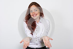 Smiling woman in a light blouse divorced aside hands isolated over a white background