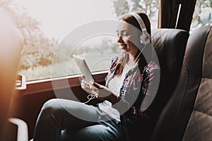 Smiling Woman Listening Music in Tourist Bus