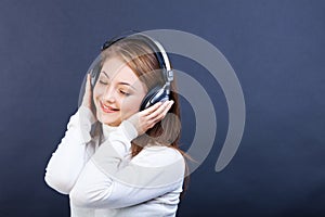 Smiling woman listening to music in headphones