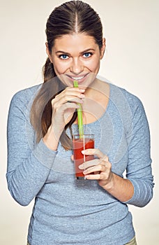 Smiling woman with long hair drink red juice