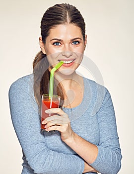 Smiling woman with long hair drink red juice