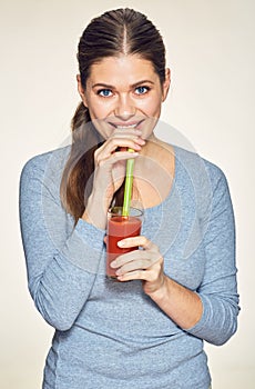 Smiling woman with long hair drink red juice