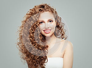 Smiling woman with long healthy curly hair background