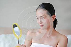 Smiling woman look at mirror. Beauty Concept