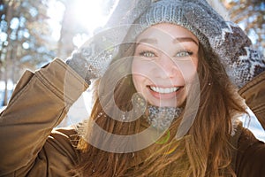 Smiling woman looking at camera in winter park