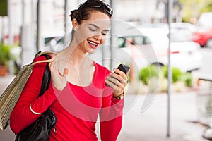 Smiling woman looking at mobile phone