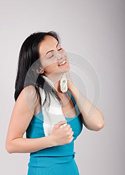 Smiling woman looking to camera and wiping sweat