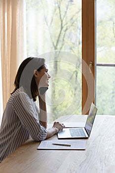 Smiling woman looks out window enjoy pleasant conversation on phonecall