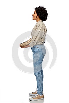 smiling woman with magazines sorting paper waste