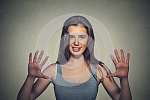 Smiling woman making five times sign gesture with hands fingers