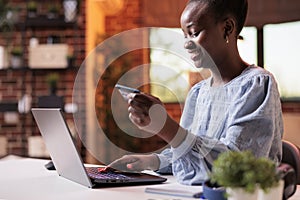 Smiling woman making purchase in internet shop