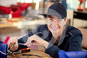 smiling woman measuring electrical current