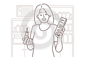 Smiling woman with meds in drugstore