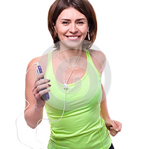 Smiling woman with mobilephone and earphones on training