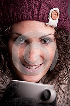 Smiling woman with a mugful of a hot drink