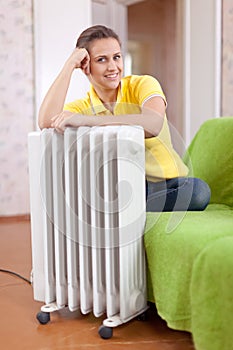 Smiling woman near warm radiator