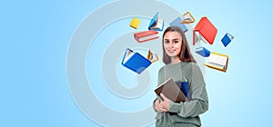 Smiling woman with notebook and flying cartoon books on copy space background