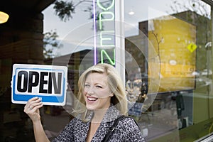 Smiling woman with an open sign