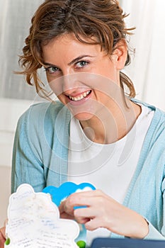 Smiling Woman Opening a Greeting Card