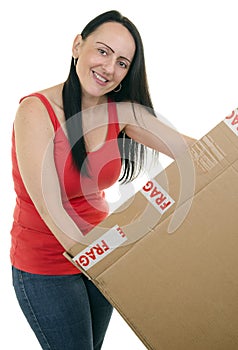 Smiling woman opening a parcel