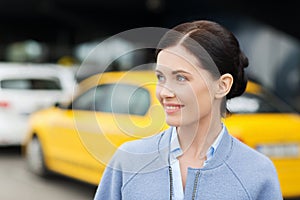 Smiling woman over taxi station or city street