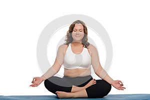 Smiling woman with overweight practices yoga