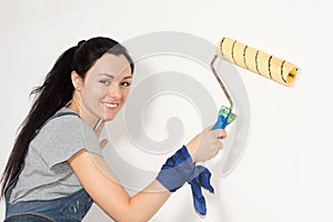 Smiling woman painting her house