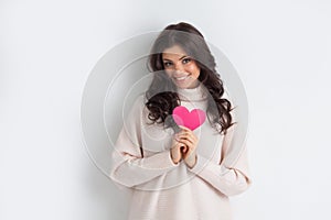 Smiling woman with paper heart