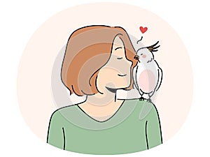 Smiling woman with parrot sitting on shoulder