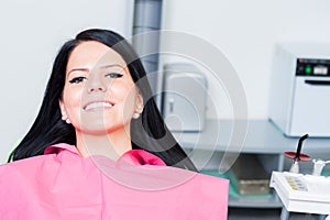 Smiling woman patient at dentist with copy space
