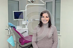 Smiling woman patient in dentistry after stomatological procedures